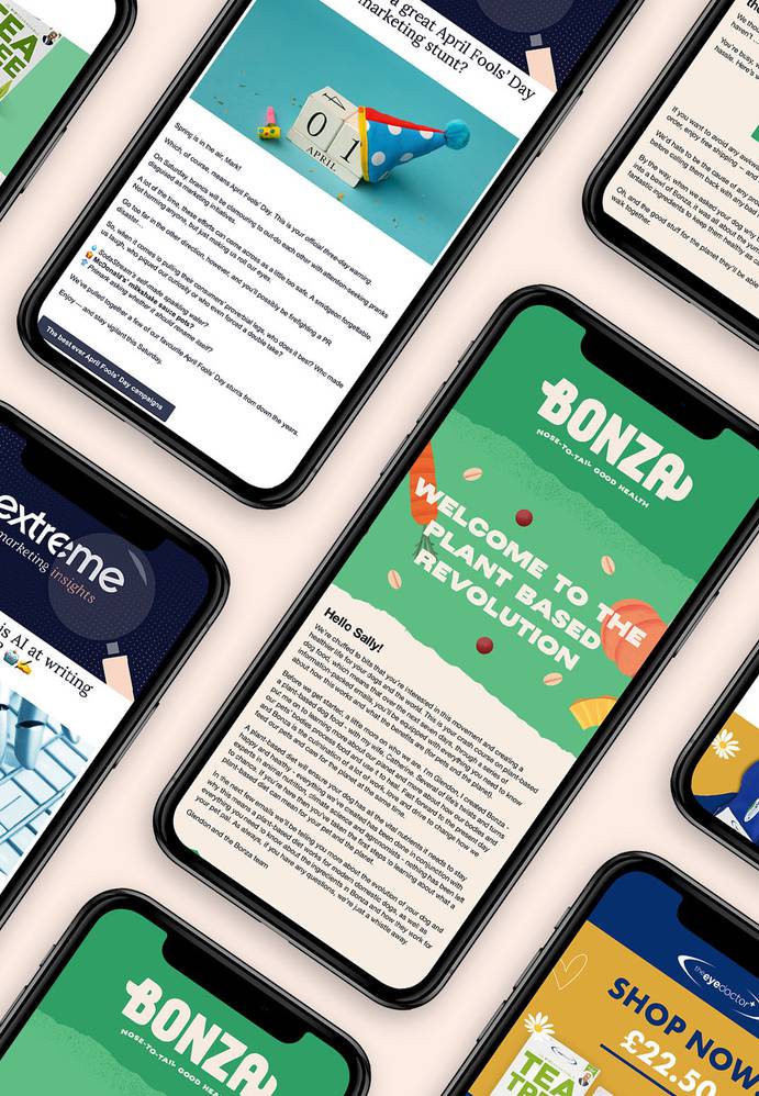 A flat lay of multiple smartphones showcasing colorful marketing emails, featuring bright designs and engaging text about various promotions.