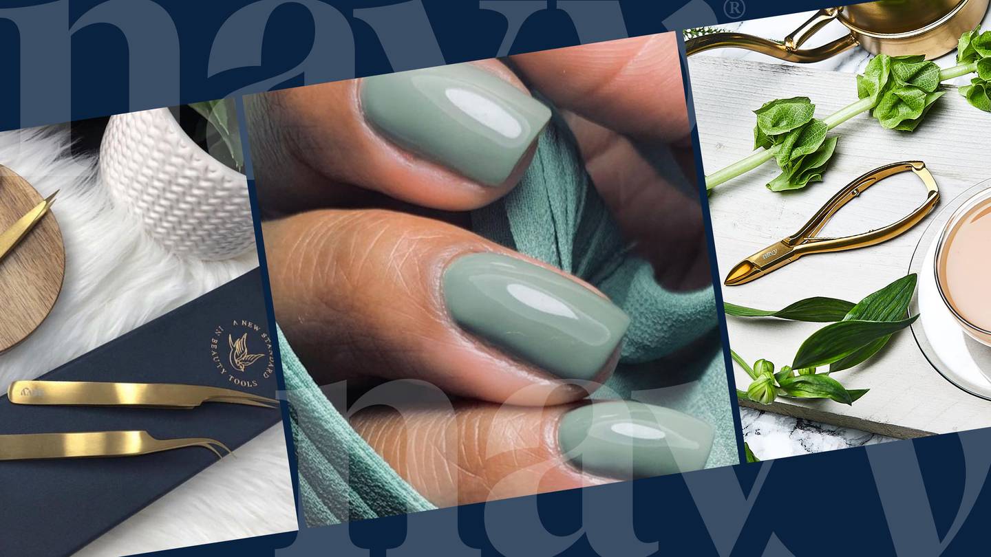 Close-up of well-manicured nails with pale green nail polish, surrounded by nail tools and beauty products on a white surface.