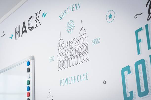 Whiteboard with a drawing of Windsor House, various text, and decorative symbols, including "HACK", "NORTHEN", "2002", and "ESTD".