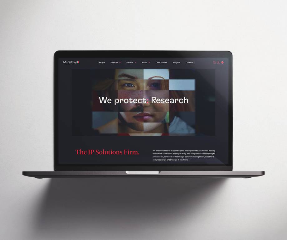 Laptop displaying Murgatroyd's website with headline "We protect: Research" and tagline "The IP Solutions Firm" overlaid on a fragmented portrait image.
