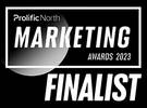 A badge indicating finalist status for the 2023 Marketing Awards, featuring bold text and a modern design with a circular element.