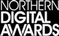 A close-up of a trophy with a golden figure holding a star, set against a sparkling background for the Northern Digital Awards.