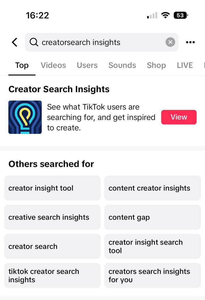 : Screenshot of a TikTok search results page for "creatorsearch insights", showing a "Creator Search Insights" card with a blue and yellow lightbulb icon and a red View button, plus a list of related search suggestions.Wait, I need to write it without prefix and roughly 150 characters, in en-GB.Screenshot of a TikTok search for "creatorsearch insights" showing a Creator Search Insights card with a lightbulb icon and red View button, plus related search suggestions below.