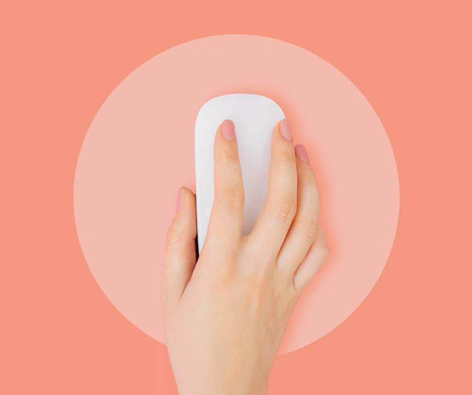 A hand using a white computer mouse on a pink background with a darker pink circle surrounding the mouse.