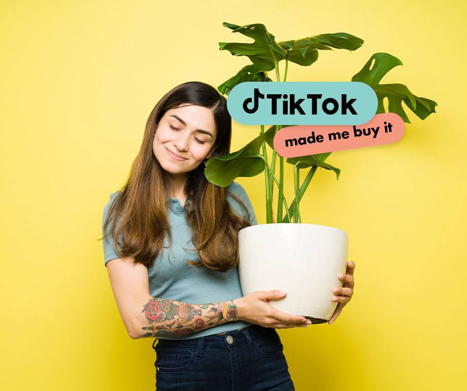 A woman with long brown hair, smiling and holding a potted plant, stands against a yellow background with TikTok-related text over the plant.