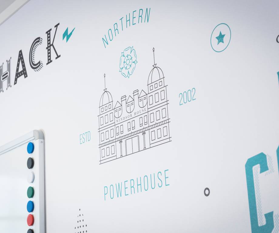 Wall with a drawing of Windsor House, the words "Northen" and "Powerhouse," and various decorative elements in blue and black.