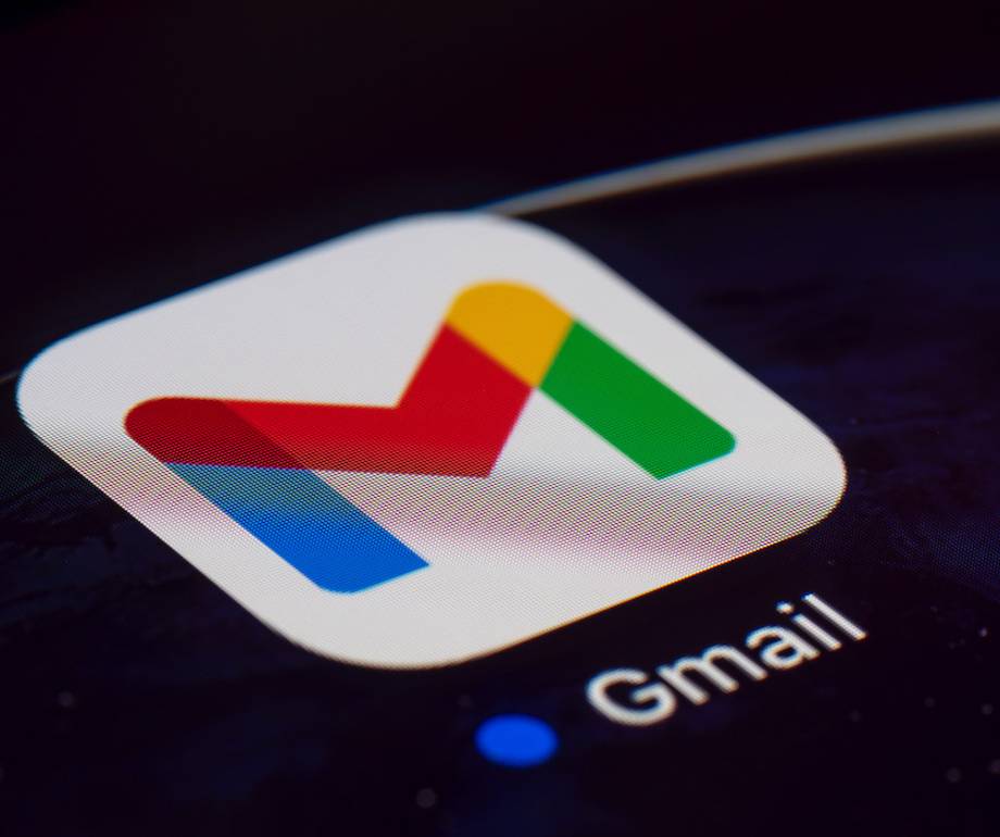 Close-up of a smartphone screen with the Gmail app icon, featuring a colourful letter "M" on a white background.