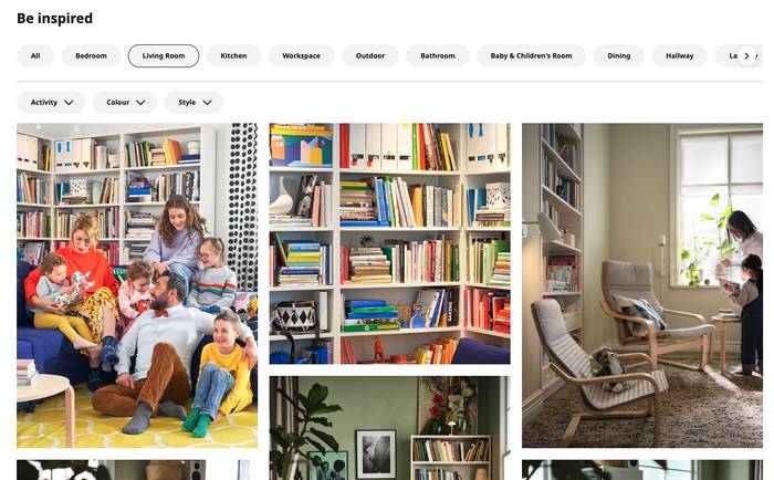 Screenshot of a Be inspired living room gallery showing a family on a blue sofa by white shelves, a colourful bookcase, and a grey armchair by a window