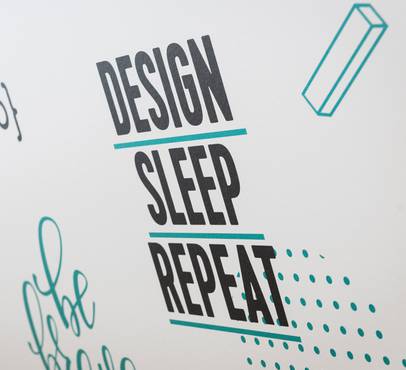 The image features the words "Design", "Sleep", and "Repeat" in bold black text with teal lines beneath each word, surrounded by minimalistic doodles on a white background.
