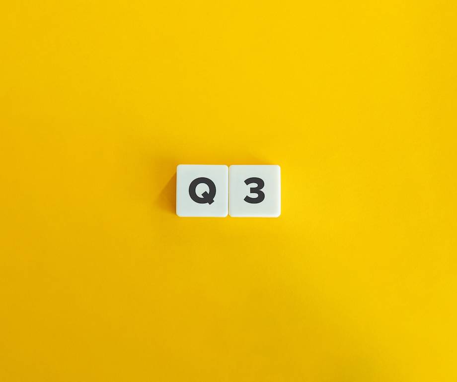 White tiles with bold black letters and numbers reading "Q" and "3" on a bright yellow background.