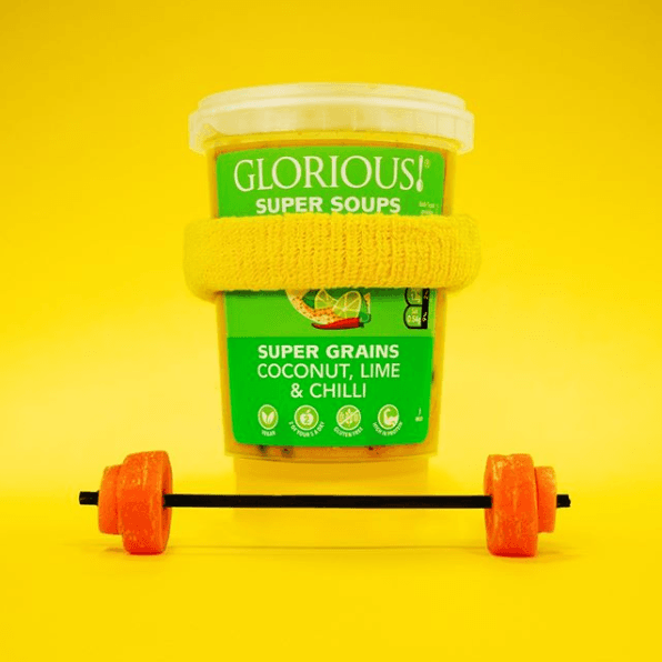 Glorious! soup pot dressed as a weight lifter with a yellow sweat band and carrot weights