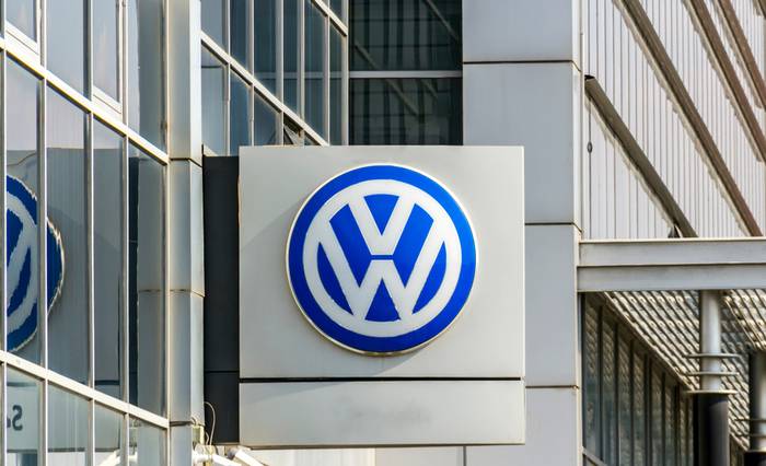 Logo of car manufacturer Volkswagen on a sign outside of a commercial office building.