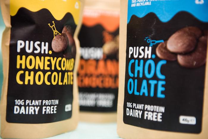 Packets of plant-based chocolate high in protein in plain and honey comb flavours