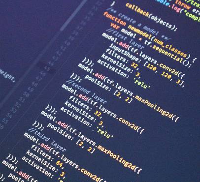Close-up of colourful programming code on a dark background, showing functions and layers in a neural network implementation.