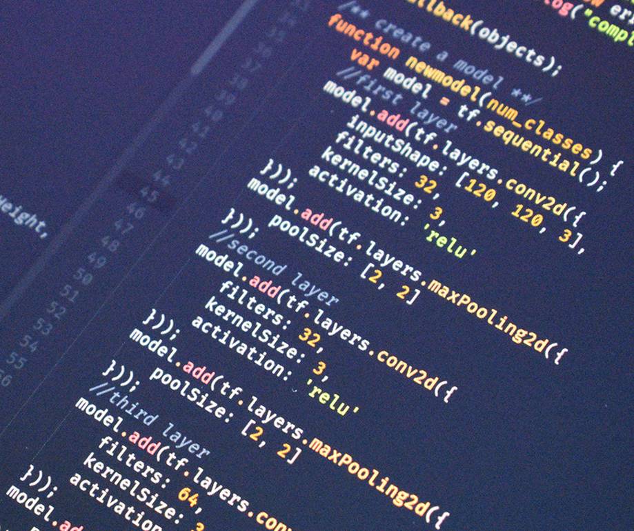 Close-up of colourful programming code on a dark background, showing functions and layers in a neural network implementation.