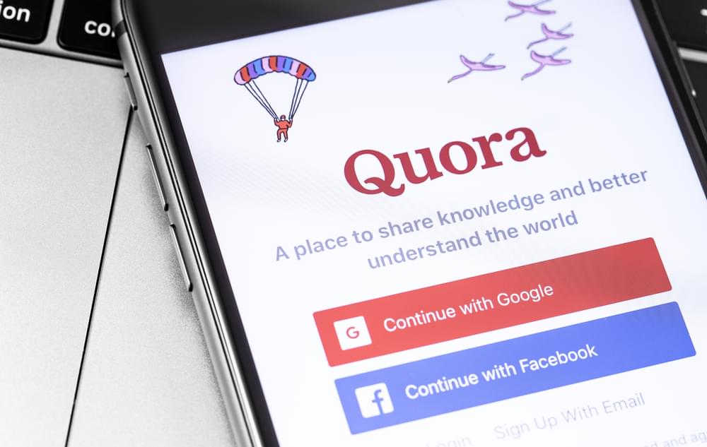 A mobile phone screen showing the Quora log in page, the logo is red.
