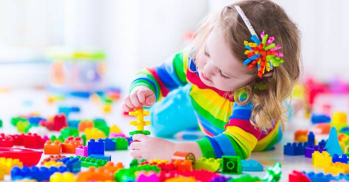 girl playing with lego