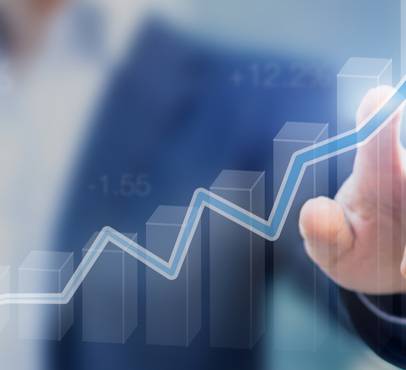 A person in a business suit touching an upward trending digital line graph, representing growth or success.
