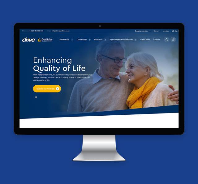 Homepage of a healthcare website featuring a smiling elderly couple, with a navigation menu and a call-to-action button on a blue background.