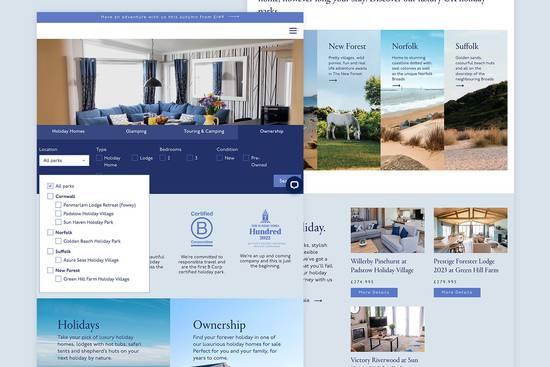 An interior shot of a modern living room with a large window, blue curtains, a blue sofa, and a coffee table with flowers.