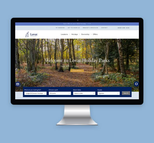 Computer screen displaying a website for Lovat Holiday Parks with a forest scene in the background and booking options below.