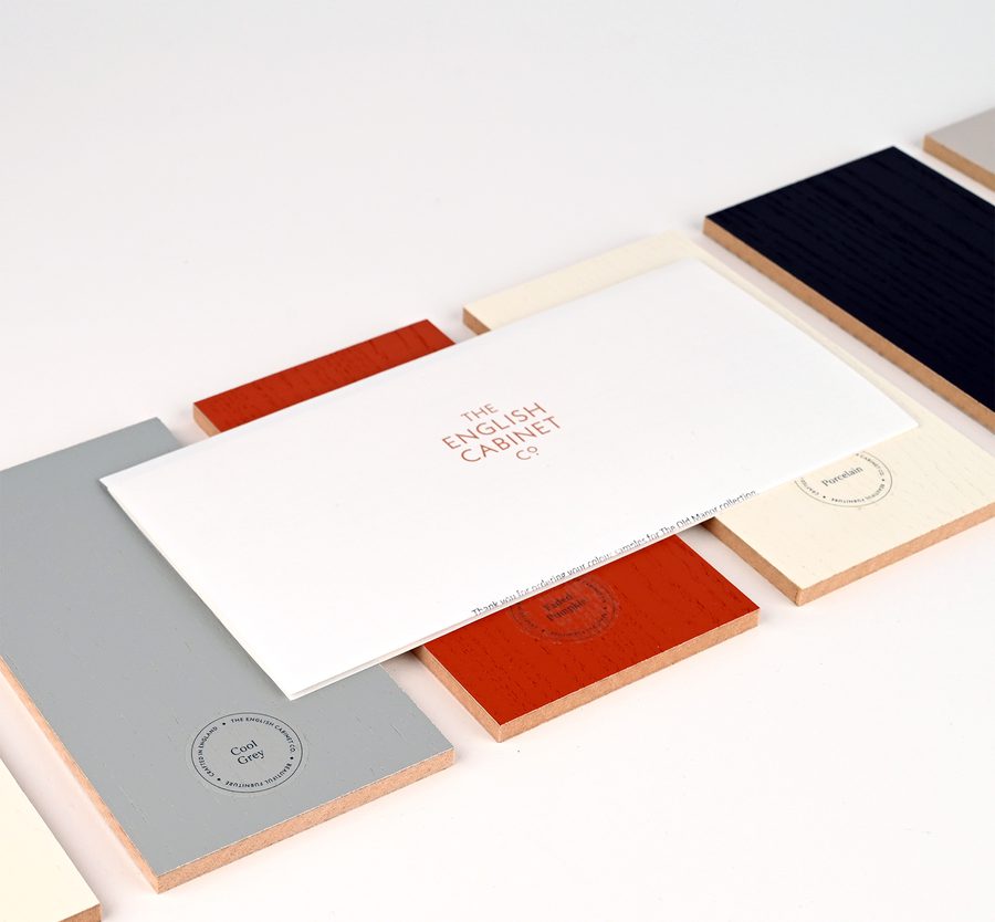 Collection of colour samples and a booklet titled 'The English Cabinet Co' arranged on a white surface.
