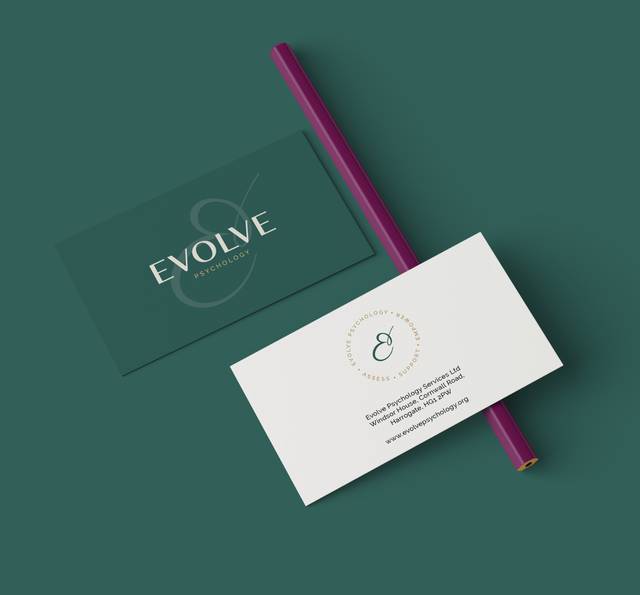Business card and flyer for Evolve Psychology with a purple pen on a teal background.