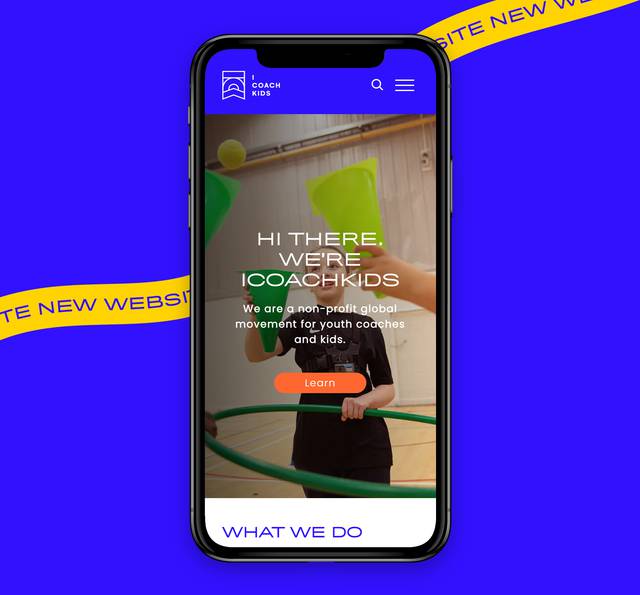 A smartphone displaying the Coach Kids homepage with a kid holding colourful sports equipment, set against a blue background with yellow banner.