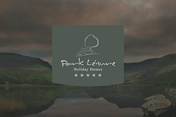A scenic landscape with a calm lake, green hills, and dark sky, featuring a logo for Park Leisure Holiday Homes in the centre.
