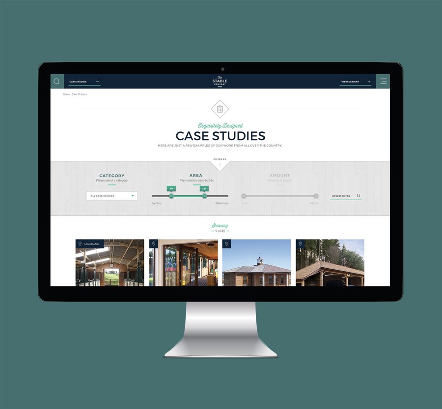 A computer monitor displaying a website for case studies with filters and thumbnail images of various buildings on a dark teal background.