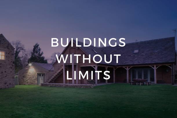 A stone and wooden house with outdoor stairs, surrounded by a lawn at dusk, overlaid with the text "BUILDINGS WITHOUT LIMITS".