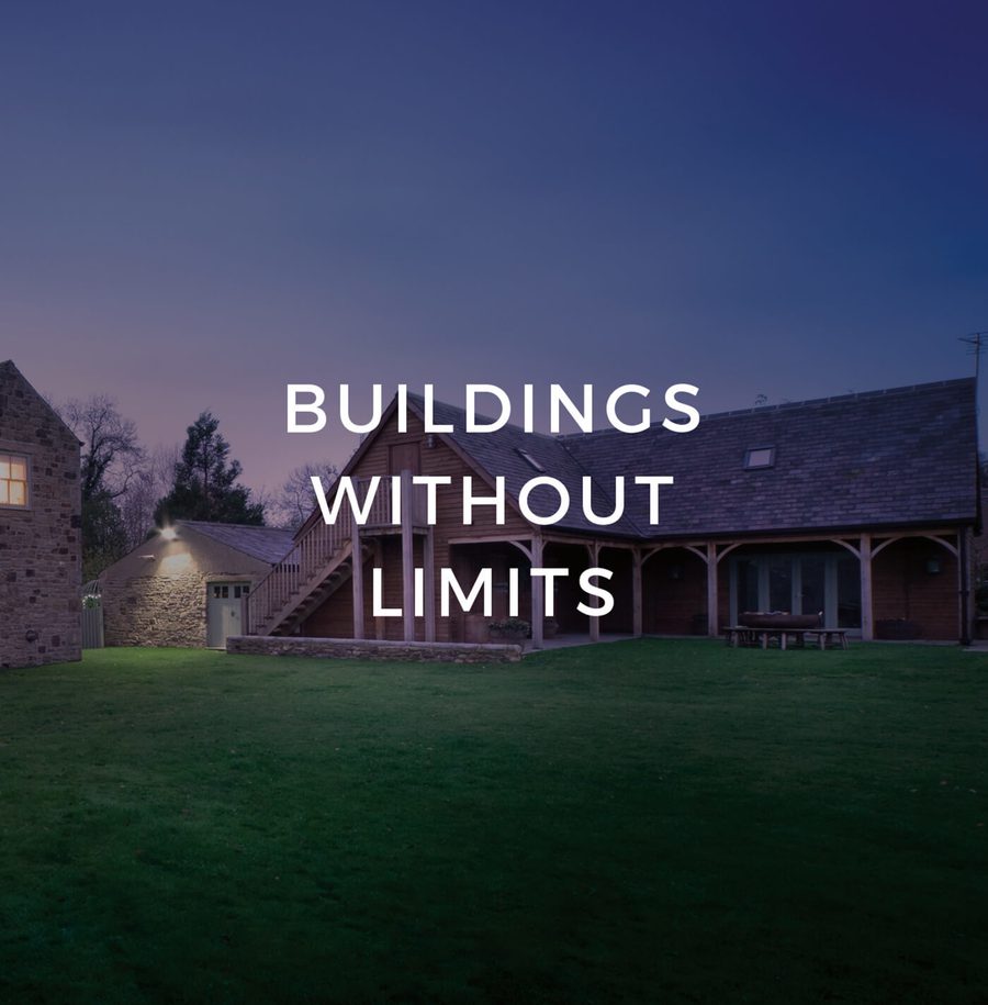 A stone and wooden house with outdoor stairs, surrounded by a lawn at dusk, overlaid with the text "BUILDINGS WITHOUT LIMITS".