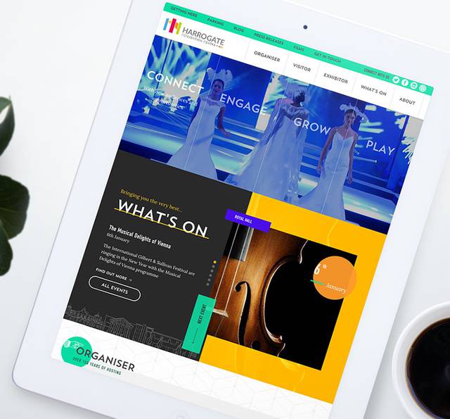A tablet displaying a colourful website for Harrogate Convention Centre with images of performers, event details, and a navigation menu.