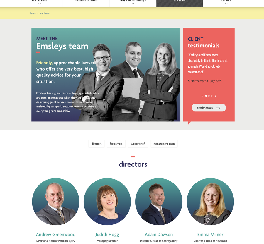 A group portrait of four professional directors, dressed in business attire, standing confidently against a clean, modern backdrop.