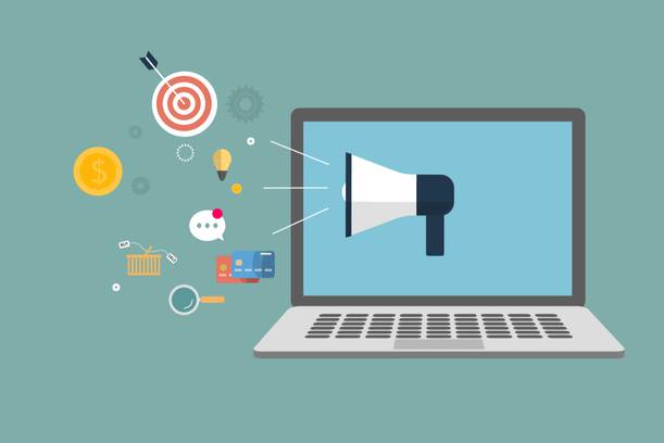 A laptop with a megaphone on the screen and various icons representing marketing, money, shopping, and communication emerging from it.