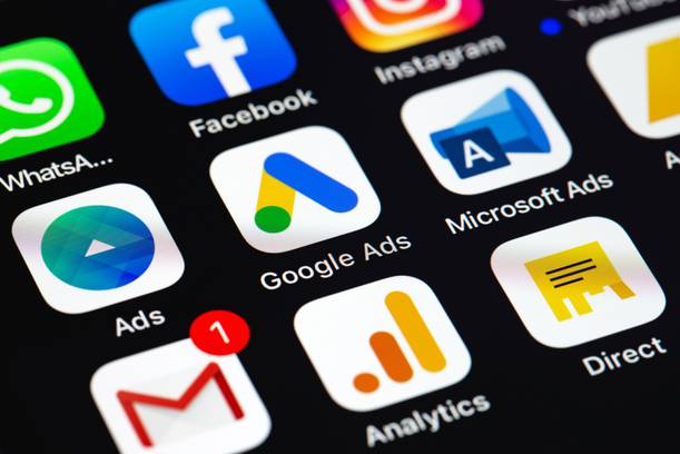 Close-up of a smartphone screen showing app icons for Facebook, Instagram, Google Ads, Microsoft Ads, and Gmail, with colourful logos on a black background.