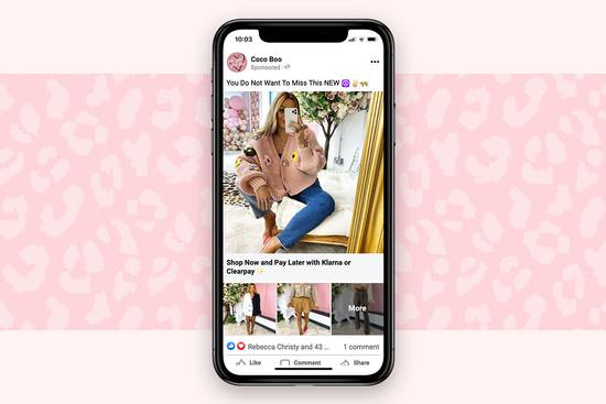 A woman taking a mirror selfie on her phone, sitting on a cream sofa with a floral backdrop and a gold curtain, surrounded by pink and neutral decor.